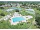 Aerial view of the community pool area with lounge chairs and palm trees at 4722 Millpond Ln, Tampa, FL 33624
