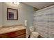 Bright bathroom featuring a framed mirror, a granite vanity, and a shower-tub combo with a striped curtain at 4722 Millpond Ln, Tampa, FL 33624