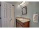 Bathroom features a granite vanity, a framed mirror, and a doorway to a walk-in closet at 4722 Millpond Ln, Tampa, FL 33624