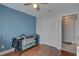 Comfortable bedroom with wood-look floors and access to closet and hall at 4722 Millpond Ln, Tampa, FL 33624