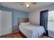 Cozy bedroom featuring a window with blinds, a ceiling fan, and an access door to another room at 4722 Millpond Ln, Tampa, FL 33624
