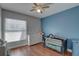 Cozy Bedroom with hardwood floors, neutral colors and a crib at 4722 Millpond Ln, Tampa, FL 33624