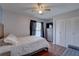 Bright bedroom featuring laminate flooring, a large window, and spacious closet for ample storage at 4722 Millpond Ln, Tampa, FL 33624