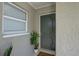 Entryway features a decorative front door, neutral paint, and a welcome mat at 4722 Millpond Ln, Tampa, FL 33624