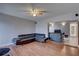 The open concept living space includes wood-look floors and a leather sofa at 4722 Millpond Ln, Tampa, FL 33624
