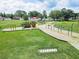 Community playground featuring a pirate ship, swings, and slides on a sunny day at 4722 Millpond Ln, Tampa, FL 33624
