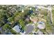 Overhead view of a home on a cul-de-sac surrounded by mature trees and manicured lawns at 50 Pembrook Cir, Palm Harbor, FL 34683