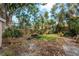 Backyard with picnic table, mature landscaping and privacy fence at 50 Pembrook Cir, Palm Harbor, FL 34683