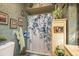Bathroom featuring a floral shower curtain, decorative plates, and framed wall art at 50 Pembrook Cir, Palm Harbor, FL 34683