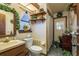 Compact bathroom with wood cabinets, a shower, and decorative plants for a cozy, natural atmosphere at 50 Pembrook Cir, Palm Harbor, FL 34683