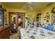 Sunlit bedroom with yellow walls, a cozy quilt, and easy access to the ensuite bathroom at 50 Pembrook Cir, Palm Harbor, FL 34683