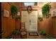 Inviting entryway with decorative door, chair, and foliage evokes a warm and charming welcome to the home at 50 Pembrook Cir, Palm Harbor, FL 34683