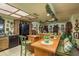 Vintage kitchen with wooden cabinets, an island with chairs, and decorative vines at 50 Pembrook Cir, Palm Harbor, FL 34683