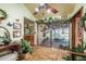 Inviting living area with a sliding glass door, plants, and view of the patio, offering a serene indoor-outdoor living experience at 50 Pembrook Cir, Palm Harbor, FL 34683