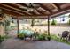 Covered outdoor patio features seating with views of the fenced backyard and pool at 50 Pembrook Cir, Palm Harbor, FL 34683