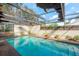 A blue swimming pool surrounded by brick, patio, white fencing and screened overhead covering at 50 Pembrook Cir, Palm Harbor, FL 34683