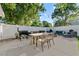 Spacious backyard with an outdoor dining table, grill and plenty of room for entertaining at 5302 S Himes Ave, Tampa, FL 33611