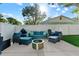 Backyard patio featuring comfortable outdoor seating, a grill, and a fire pit for relaxing evenings at 5302 S Himes Ave, Tampa, FL 33611