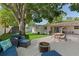 Inviting backyard with patio seating, fire pit, and well-manicured lawn for outdoor enjoyment at 5302 S Himes Ave, Tampa, FL 33611