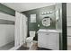The updated bathroom has a shower, toilet, and a white vanity at 5302 S Himes Ave, Tampa, FL 33611