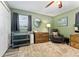 Cozy Bedroom featuring a changing station, wooden dresser, soft rug, and serene green walls at 5302 S Himes Ave, Tampa, FL 33611