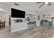 Open-concept kitchen featuring modern appliances and a breakfast bar with stylish stools at 5302 S Himes Ave, Tampa, FL 33611