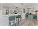 Bright kitchen with stainless steel appliances, white cabinets, and barstool seating at 5302 S Himes Ave, Tampa, FL 33611