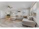 Bright living room featuring a large sectional sofa, ceiling fan, and natural light at 5302 S Himes Ave, Tampa, FL 33611