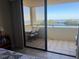 Balcony overlooking a scenic waterfront view with seating and partial bedroom view at 5915 Sea Ranch Dr # 512, Hudson, FL 34667