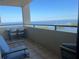 Enjoy breathtaking water views from the private balcony with chairs, ideal for relaxation and outdoor living at 5915 Sea Ranch Dr # 512, Hudson, FL 34667
