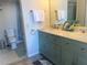 Bright bathroom featuring a dual-sink vanity, with a tiled shower and modern fixtures, creating a comfortable space at 5915 Sea Ranch Dr # 512, Hudson, FL 34667