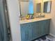 Bathroom featuring a double vanity with marble countertops, decorative mirrors, and a separate shower at 5915 Sea Ranch Dr # 512, Hudson, FL 34667