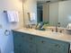 Bathroom showcasing a dual-sink vanity with a stone countertop, accompanied by ample storage and stylish decor at 5915 Sea Ranch Dr # 512, Hudson, FL 34667