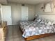 Cozy bedroom featuring a large bed with a patterned quilt and a dresser, creating a relaxing atmosphere at 5915 Sea Ranch Dr # 512, Hudson, FL 34667