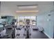 A gym with cardio machines and a window overlooking an outdoor scene at 5915 Sea Ranch Dr # 512, Hudson, FL 34667