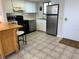 Efficient kitchen with stainless steel appliances, white cabinets, and a tiled floor at 5915 Sea Ranch Dr # 512, Hudson, FL 34667
