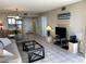 Inviting living room featuring a comfortable sofa, dining area, and a view of the kitchen at 5915 Sea Ranch Dr # 512, Hudson, FL 34667