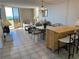 Bright and airy living room with tile flooring, comfortable seating, and access to a balcony with ocean views at 5915 Sea Ranch Dr # 512, Hudson, FL 34667