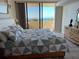 Bright main bedroom with balcony access and serene ocean view at 5915 Sea Ranch Dr # 512, Hudson, FL 34667