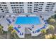 Aerial view of a clean community pool with lots of lounge seating at 5915 Sea Ranch Dr # 512, Hudson, FL 34667
