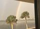 Condo view of swaying palms and a rainbow over the water at 5915 Sea Ranch Dr # 512, Hudson, FL 34667