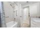 Bright bathroom features tile walls, safety bars, shower with tub, and marble countertop at 6345 Dartmouth N Ave, St Petersburg, FL 33710