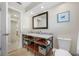 Contemporary bathroom with decorative mirror, stainless faucet and hardware, and open storage at 6345 Dartmouth N Ave, St Petersburg, FL 33710