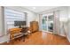 Bedroom with hardwood floors, natural light, a desk, dresser and sliding door to the pool at 6345 Dartmouth N Ave, St Petersburg, FL 33710