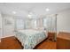Bright bedroom with hardwood floors, ceiling fan, and natural light coming through the windows at 6345 Dartmouth N Ave, St Petersburg, FL 33710