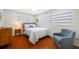 Bedroom with neutral colors, hardwood floors, and comfortable seating at 6345 Dartmouth N Ave, St Petersburg, FL 33710