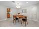 Bright dining area with a round wooden table, seating for four, and terrazzo flooring at 6345 Dartmouth N Ave, St Petersburg, FL 33710