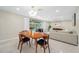 Dining area with table, and chairs, seamlessly blending indoor space with an outdoor pool view at 6345 Dartmouth N Ave, St Petersburg, FL 33710