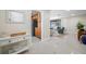 Bright entryway flows into living space with terrazzo floors, with a glimpse of the screened-in patio at 6345 Dartmouth N Ave, St Petersburg, FL 33710