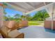 Inviting front porch with brick accents and a cozy seating area, perfect for enjoying the outdoor view at 6345 Dartmouth N Ave, St Petersburg, FL 33710